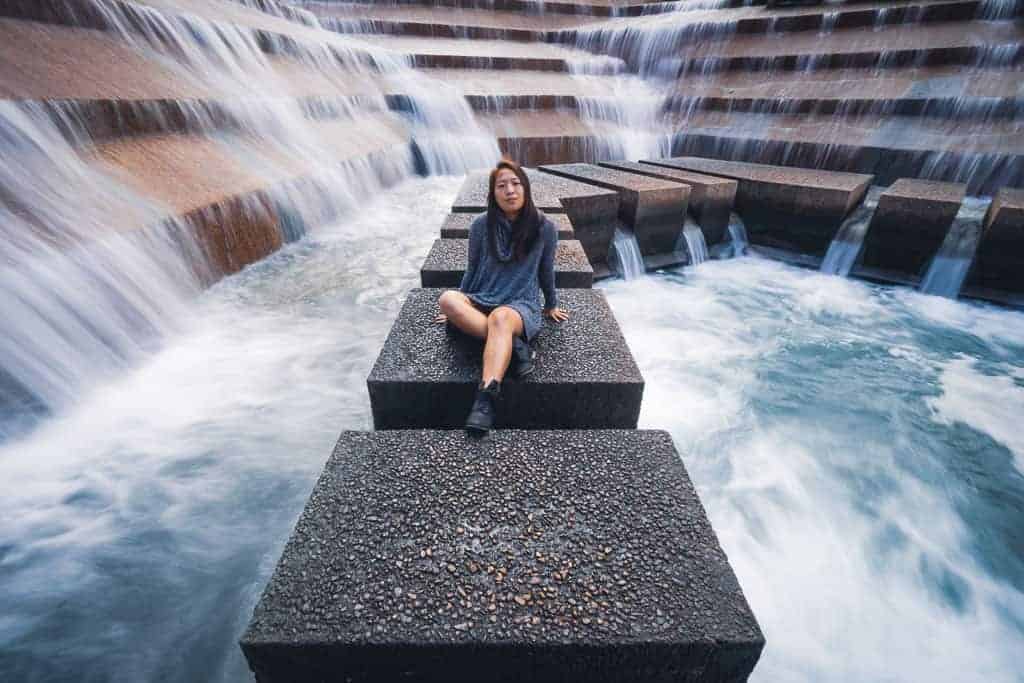 Catherine Xu sitting at fort forth water gardens