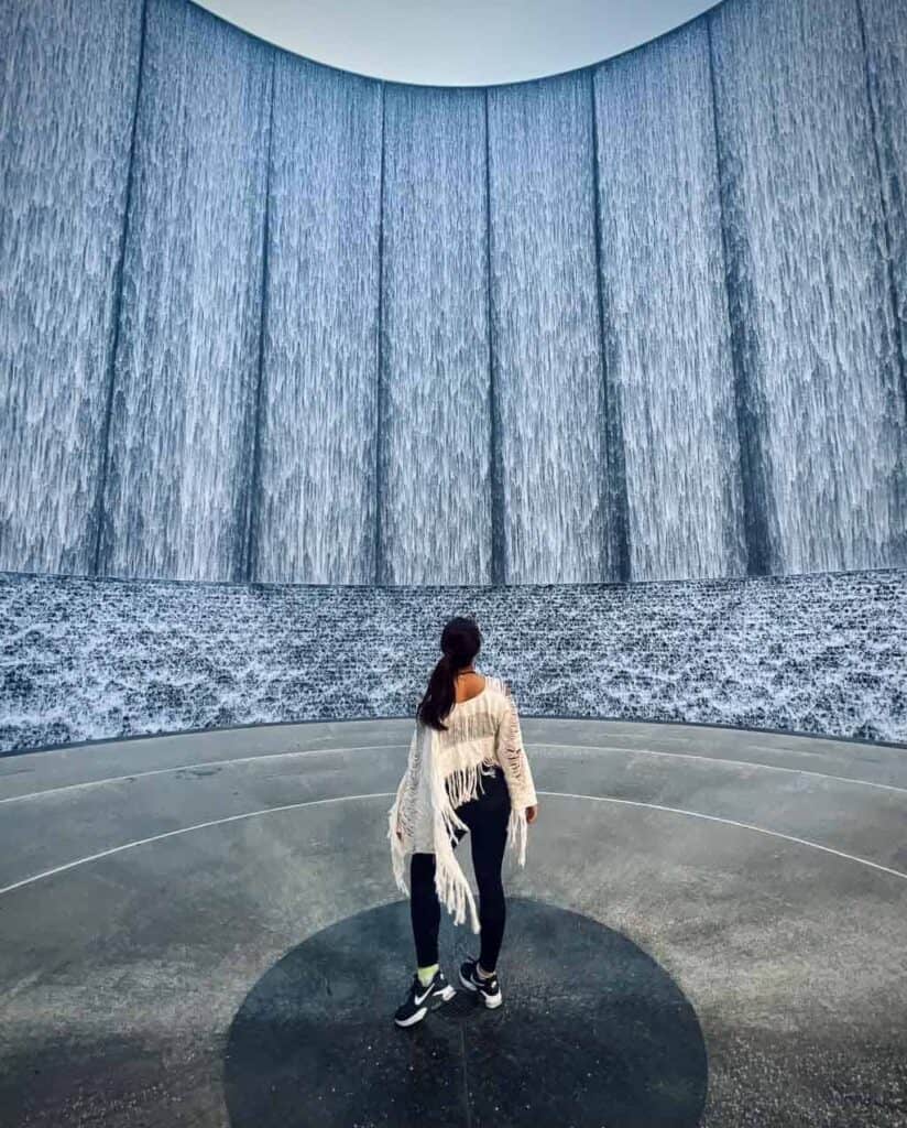 day trip nomad in white at Gerald D. Hines Waterwall Park, a can't miss stop on a one day in Houston itinerary