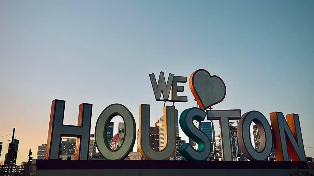 Giant I Love Houston sign with the skyline at sunset