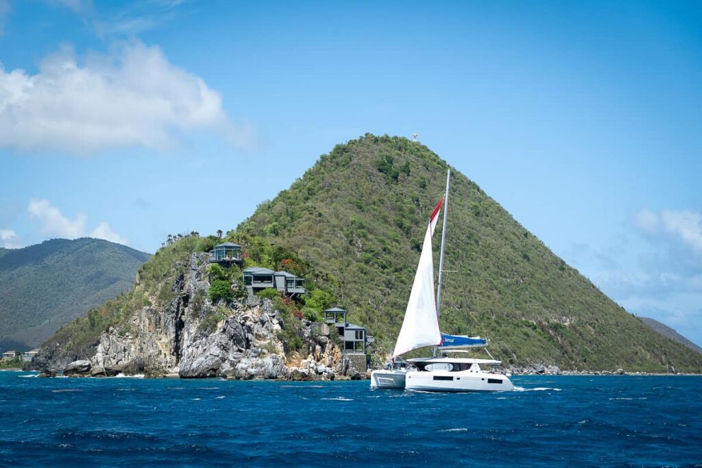 Sailboat crossing in front of Virgin Islands greenery