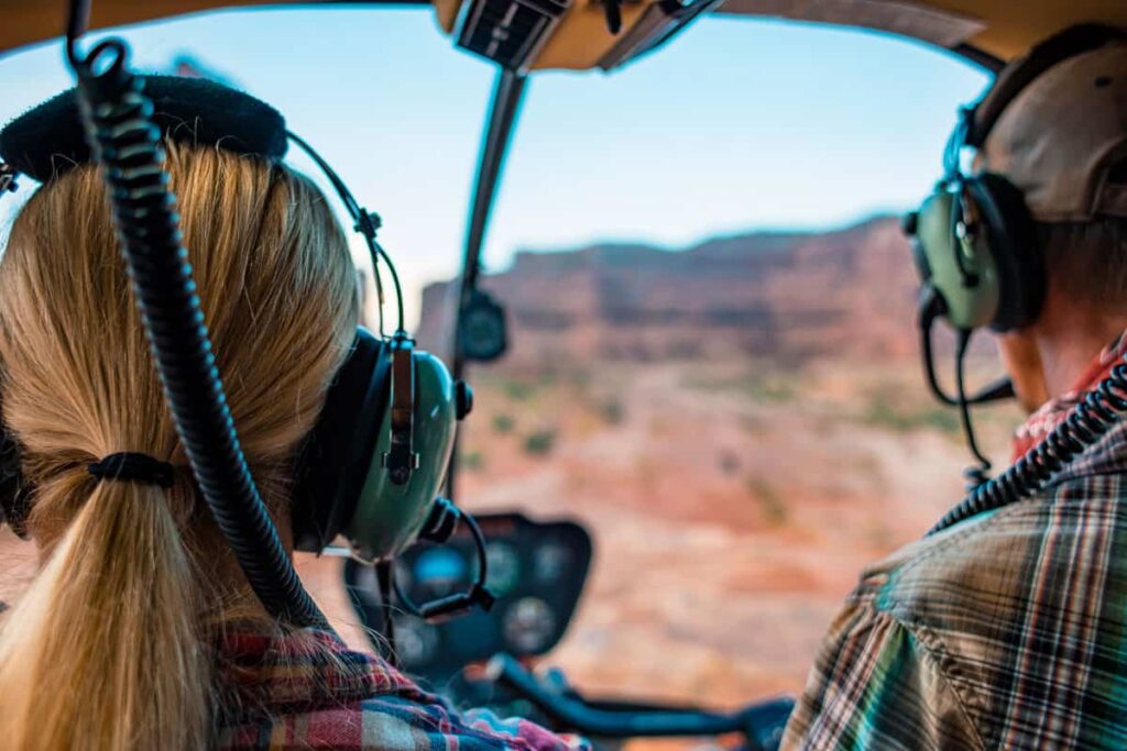 Woman Taking moab Helicopter tours over the canyons of utah