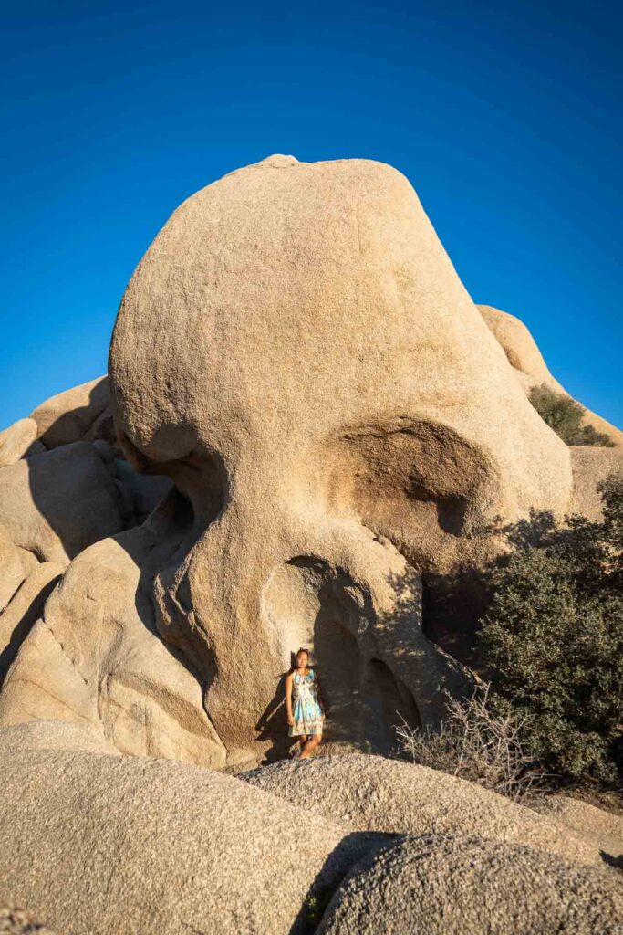 cat xu posing in front of skull rock, one of the best things to do in joshua tree