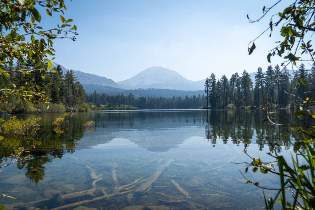 the clear waters of reflection lake with lassen peak in the background