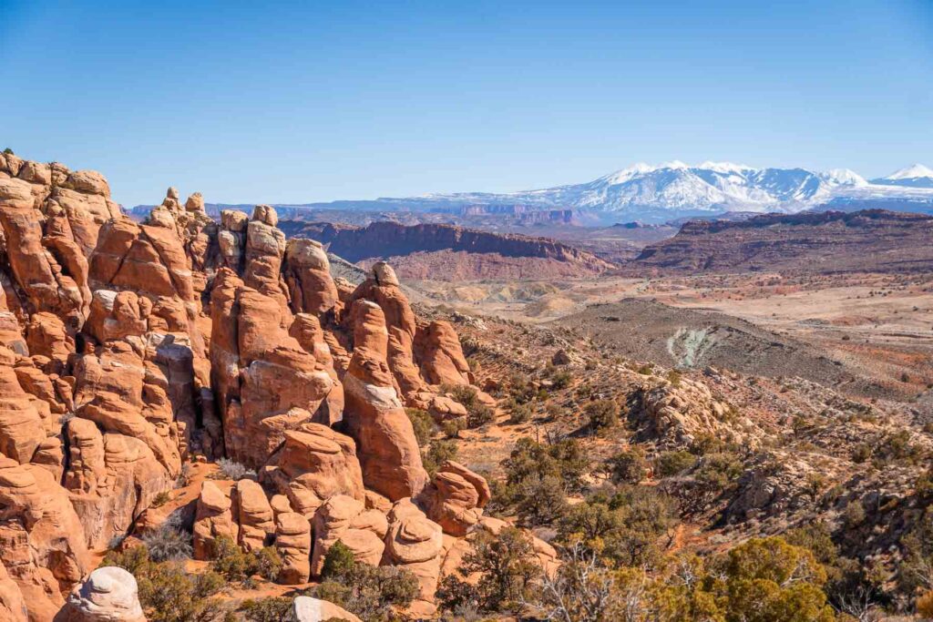 A panoramic view of the Fiery Furnace with its maze-like collection of narrow sandstone canyons with the la sal mountains in the back