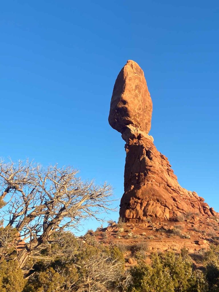 A close-up shot of Balanced Rock, precariously perched on a slender pedestal