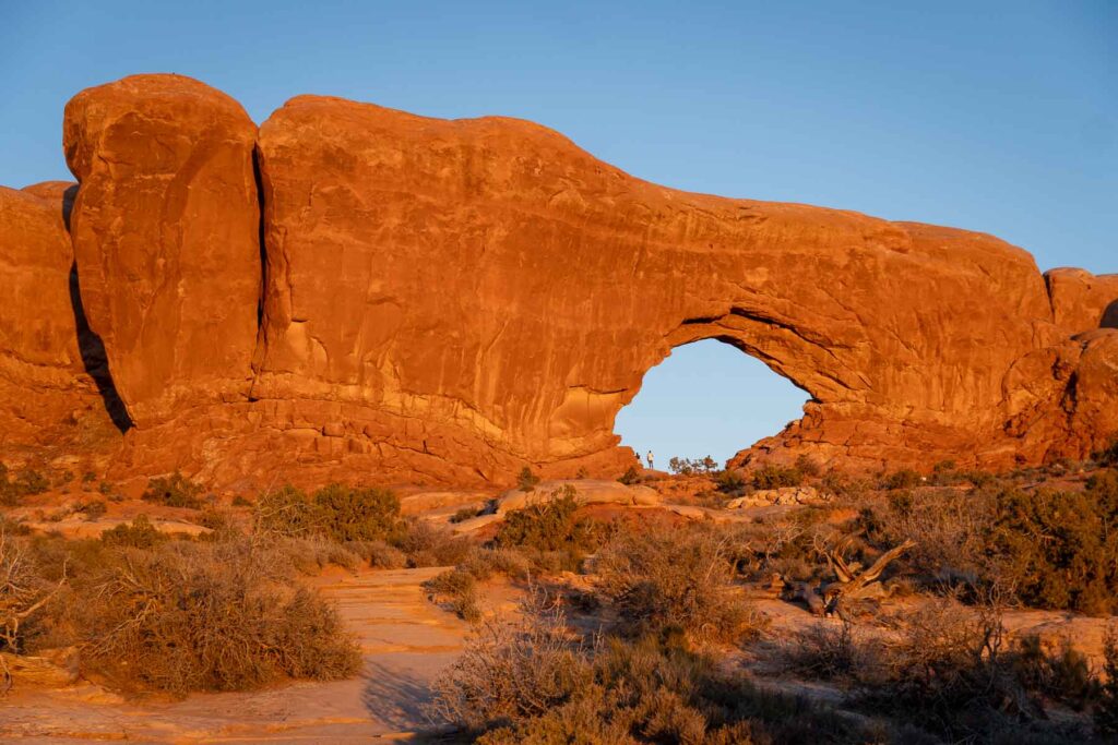 Sunset casting a golden glow on the Windows, one of the best places to go on a one day in narches national park itinerary