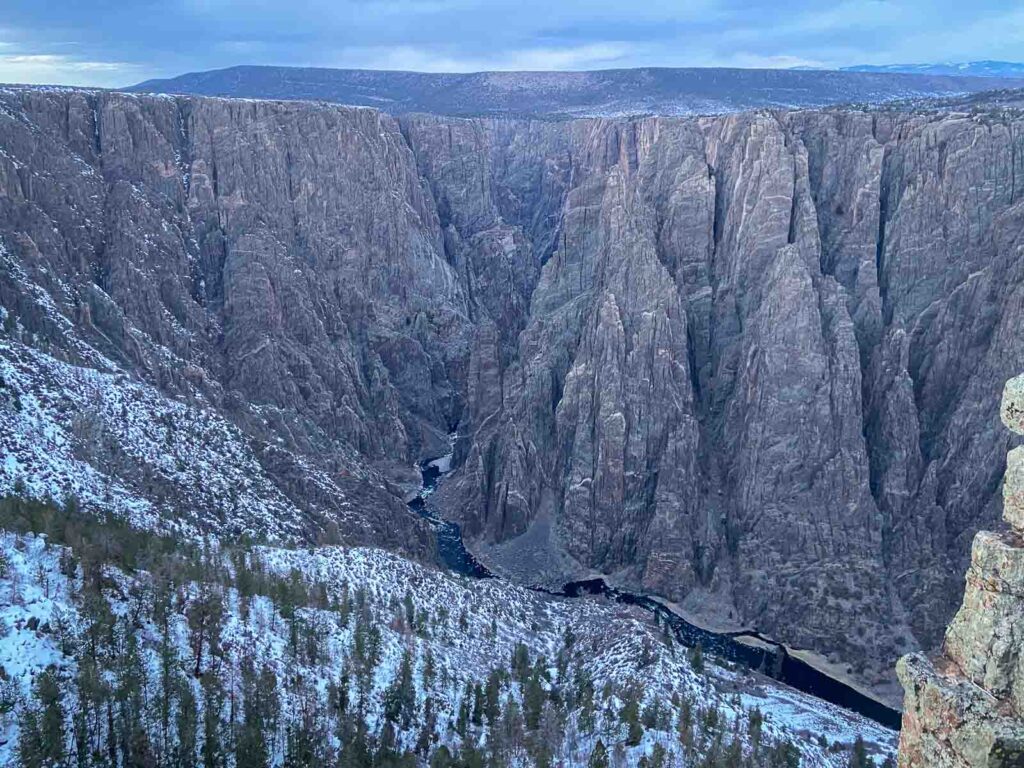 View of the steep Black Canyon walls with Gunnison River flowing.