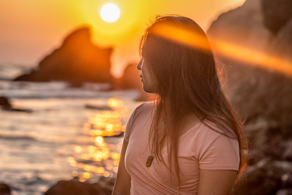 Cat Xu facing the sun on matador beach in malibu, california