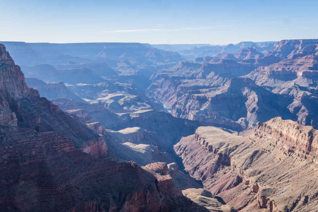 the afternoon purpole light in the grand canyon with the colorado river view