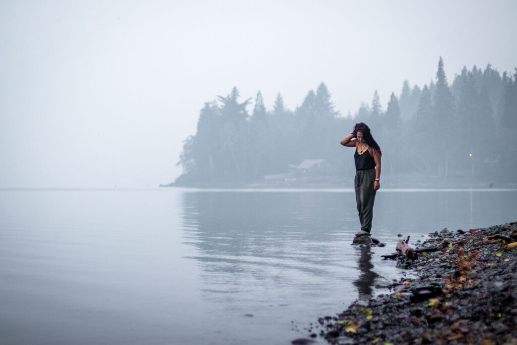 day trip nomad 's author cat xu standing on a misty crescent lake