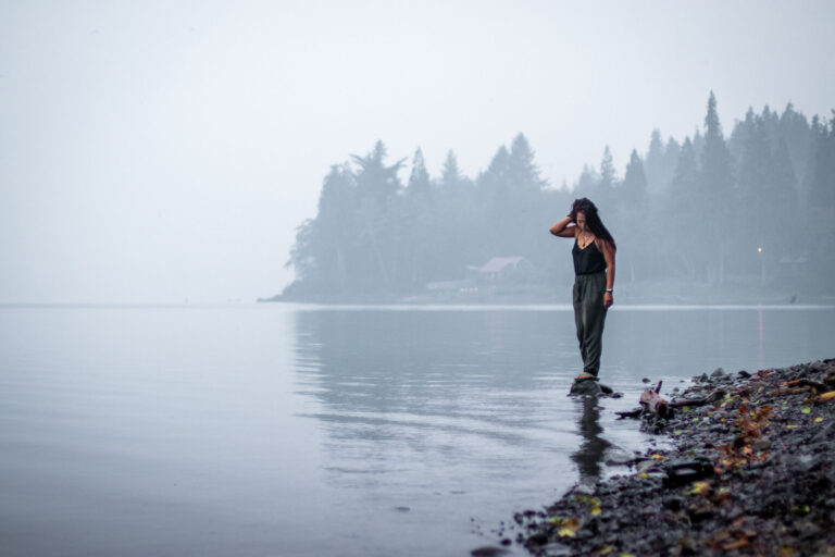 day trip nomad 's author cat xu standing on a misty crescent lake