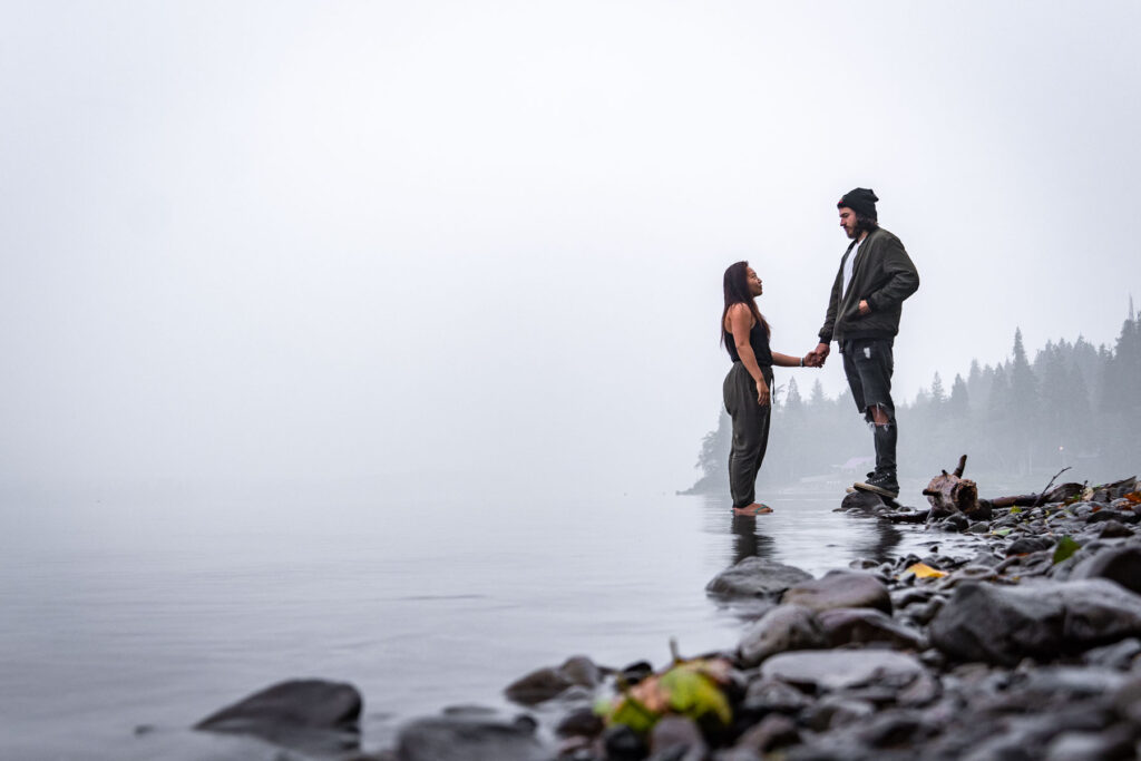 cat xu and friend holding hands on the foggy view of crescent lake in olympic national park