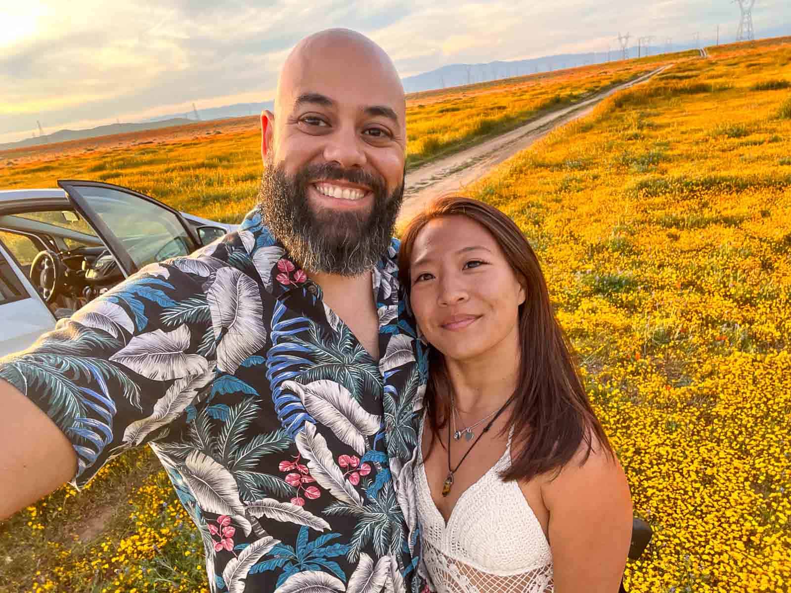 cat xu and brazilian friend smiling in front of the california poppy fields