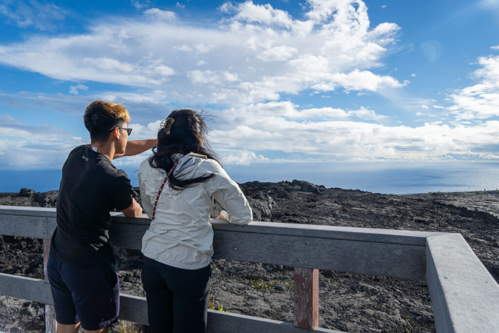 my two friends looking out over the devasted area on a day trip to volcano national park itinerary