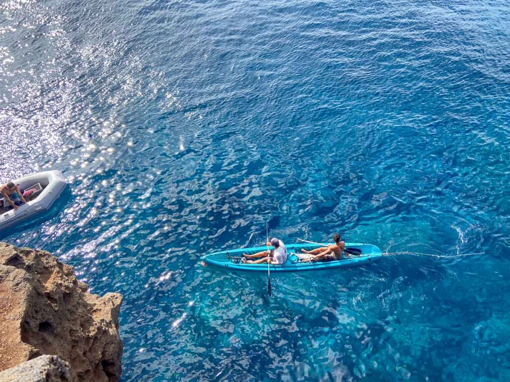 Lookoing down at a double kayak on the highest cliff jumping place in big island