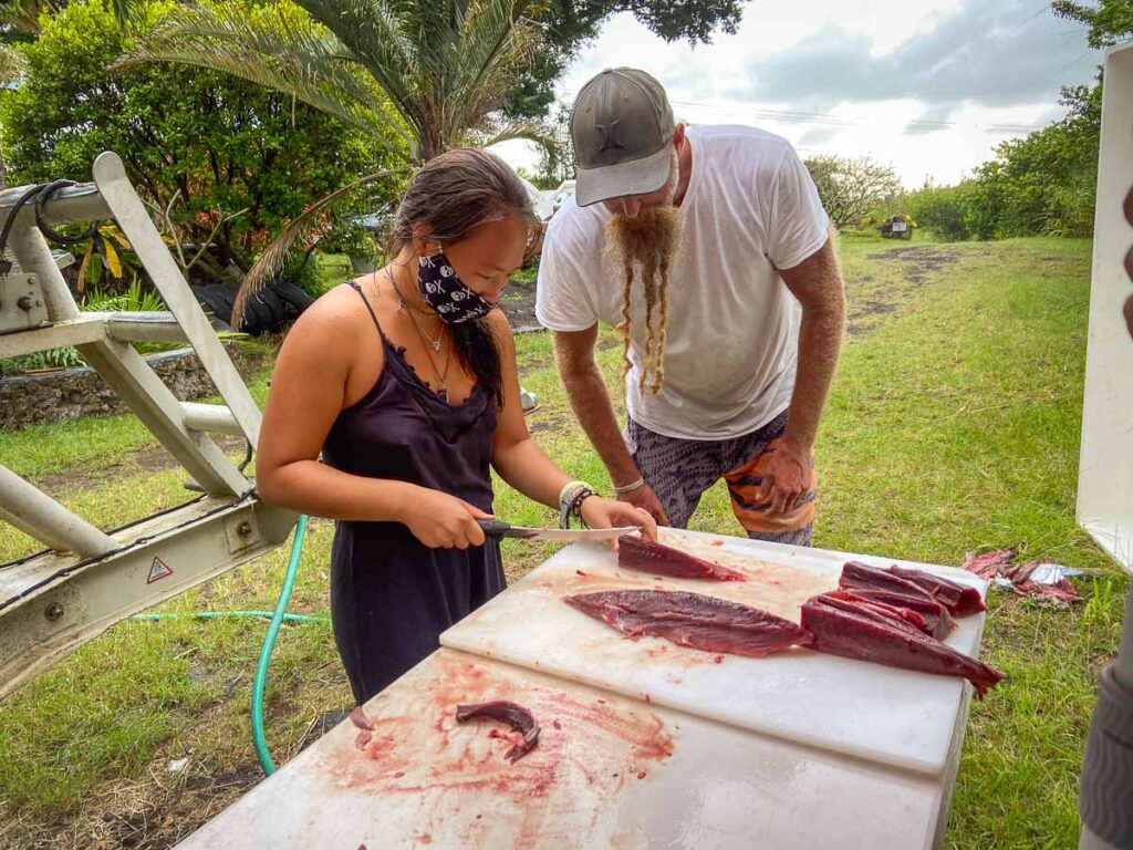 Catherine Xu learning to slice fish on a one day in big island itinerary