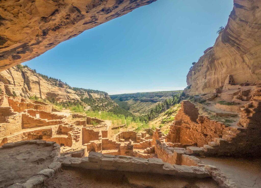 View out from rock overhang to canyon and ruins of old clay town