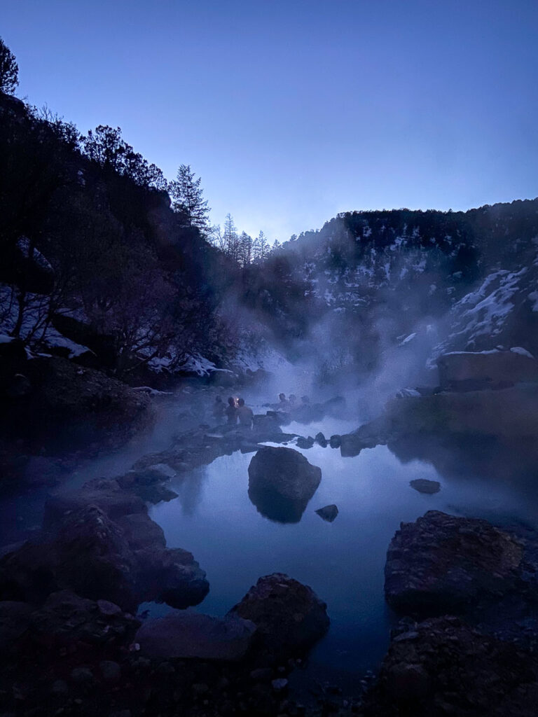 the spanish fork hot springs at night with steam 