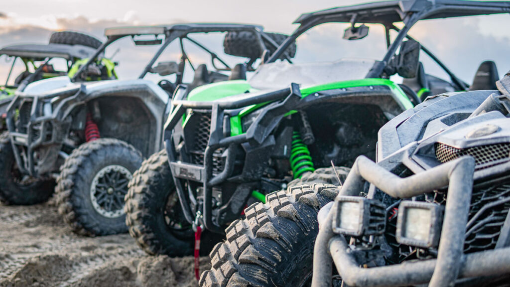 The buggies parked on the sandy area in the desert for Moab ATV tours