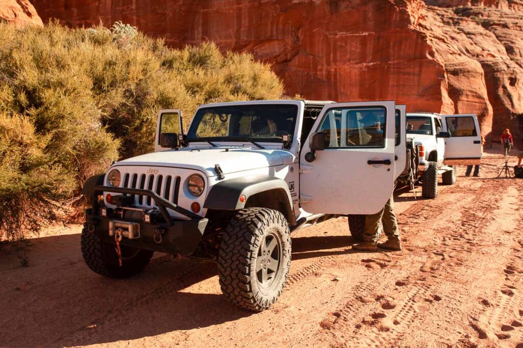 A white jeep on a dirt Utah road on one of the best zion jeep tours