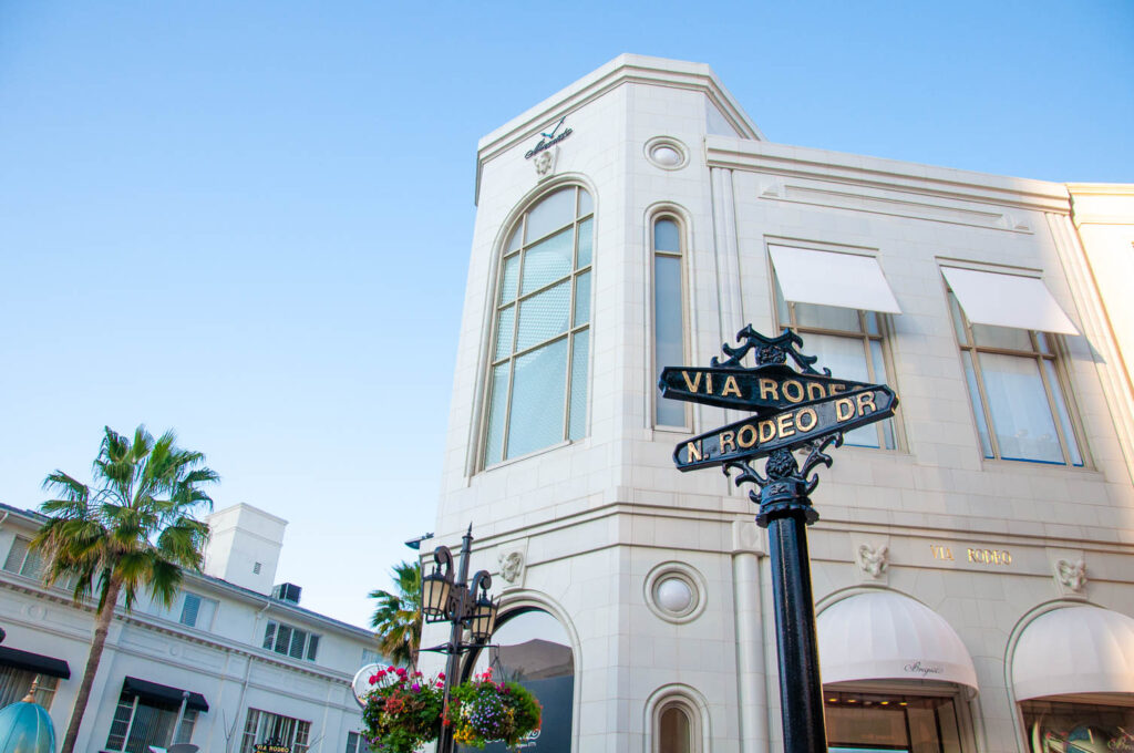 Tha famous Rodeo Drive sign in front of a white building