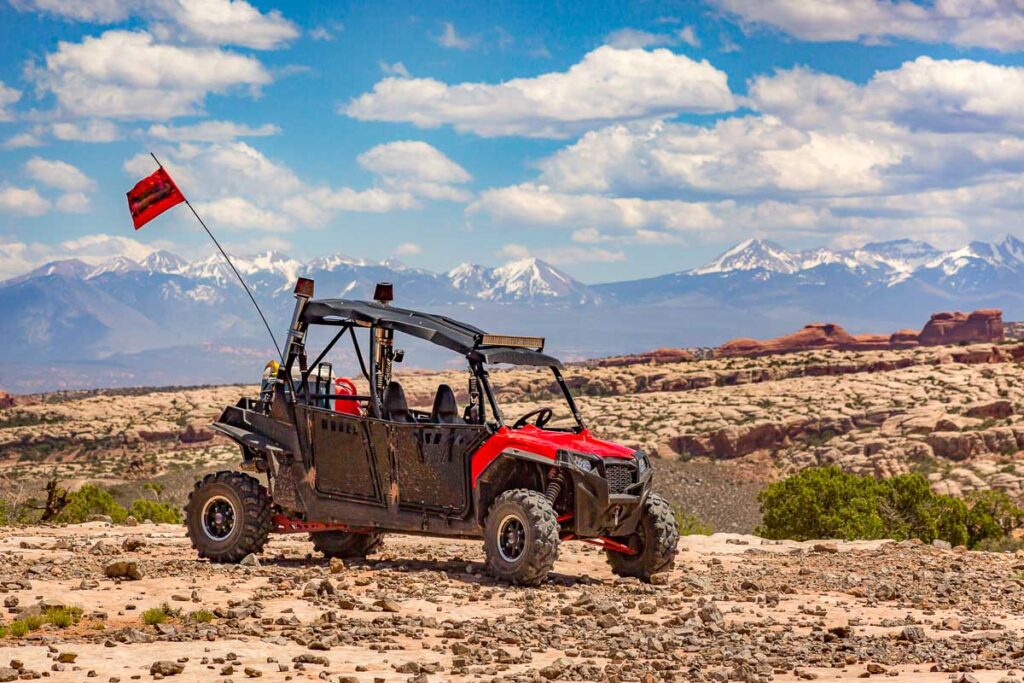 The La Sal Mountains are sitting in the background of an atv