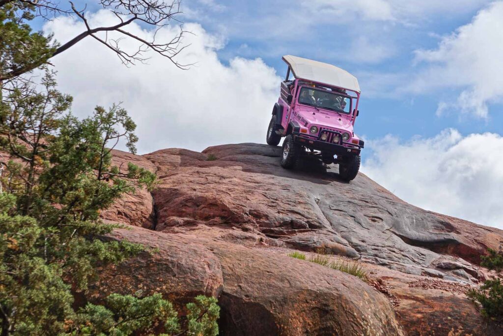 Customized vehicles of Pink Jeeps Tours take tourists for a thrilling off-road ride on Broken Arrow Road, Coconino National Forest.