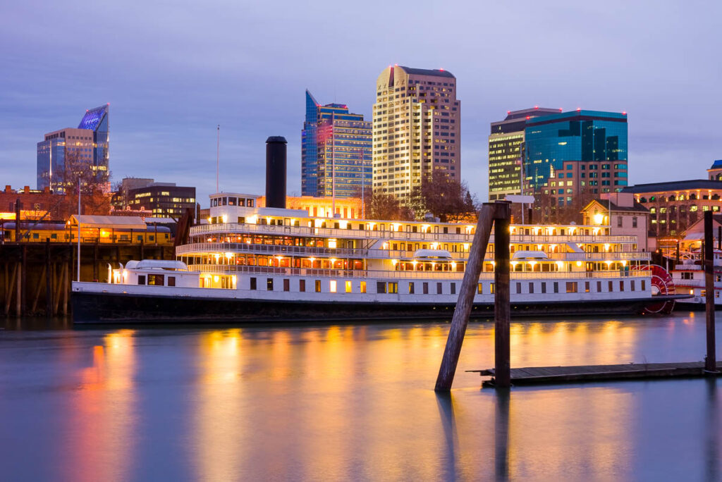 Sacramento River Cruise in front of the skyline at dusk. This is one of the best things to do on a one day in Sacramento itinerary