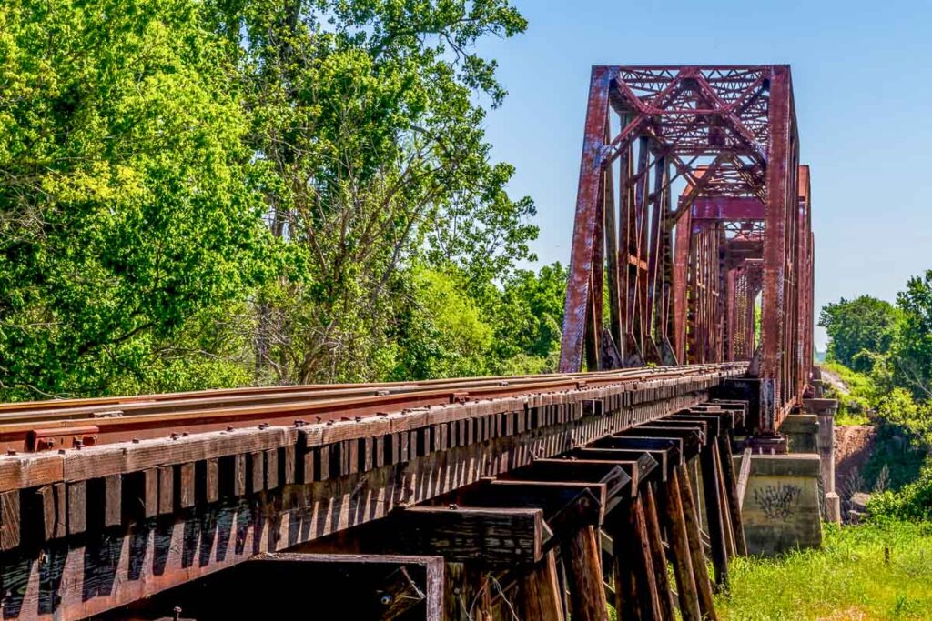 Old train bridge in Texas surrounded by trees