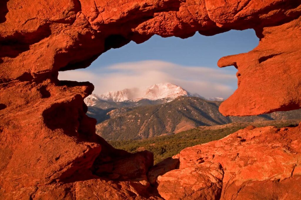 Framng up a cloudy Pikes Peak from the Siames Twins Rock Formation at Garden of the Gods, Colorado