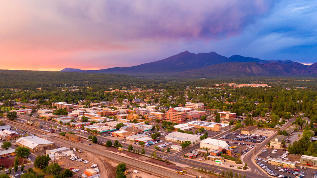 Blue and Orange color swirls around in the clouds at sunset over Flagstaff Arizona