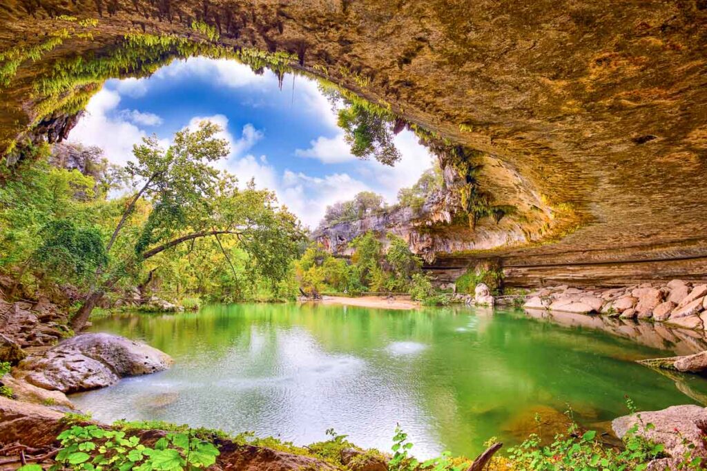 Hamilton Pool sink hole on a sunny day with green water, Texas, United States