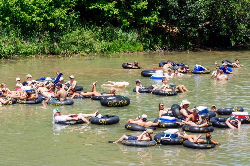 Several people flowing down the Guadalupe River known for its large increased visitor traffic for the summer time. Tubers where taken in New Braunfels, Texas.