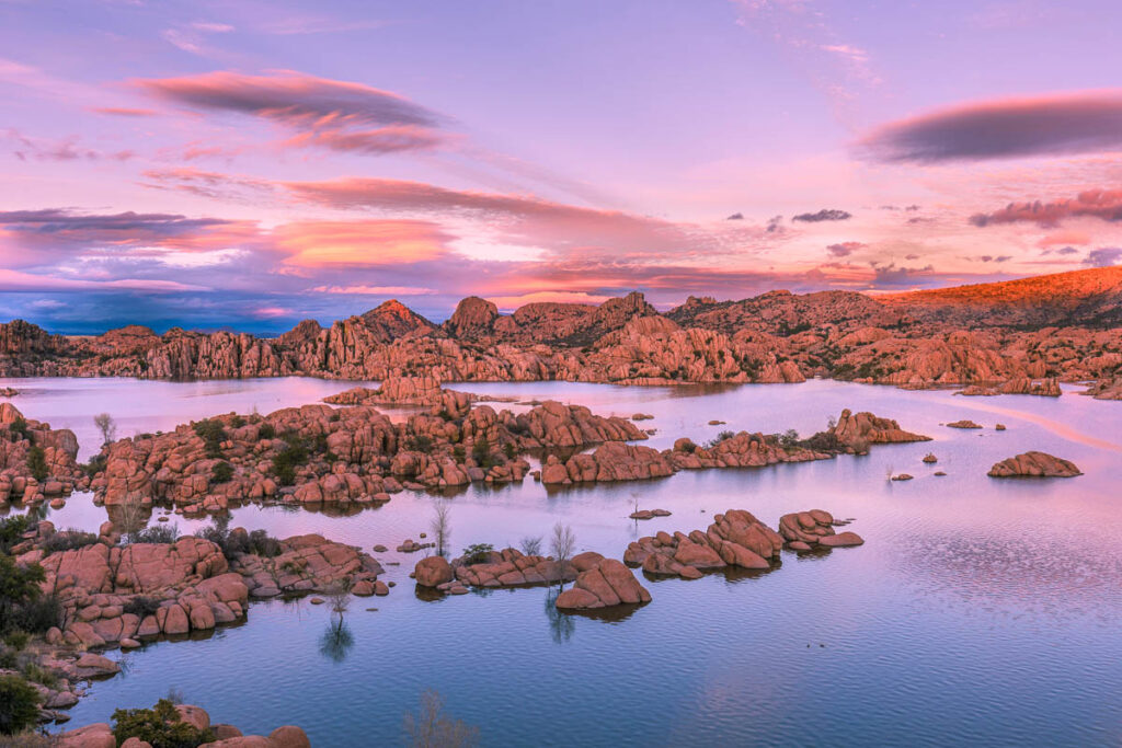 The boulders breached in a lake in Prescott during the sunset