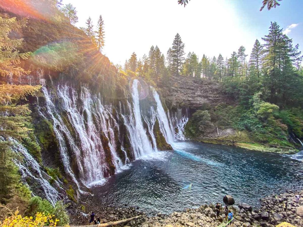 Sun peeking over Burney Falls in northern California