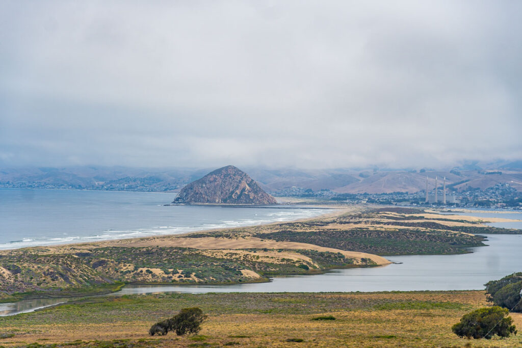 Faraway aerial view of Morro Bay Rock on a cloudy day