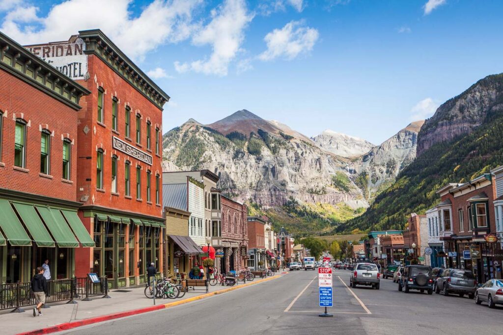 Downtown Teullride with mountains in the backdrop, one of the Best Places to Visit in Colorado