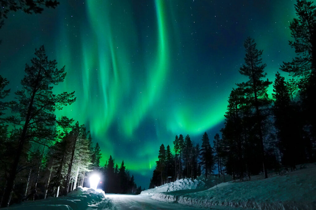 Northern lights over a snowy path in Northern USA