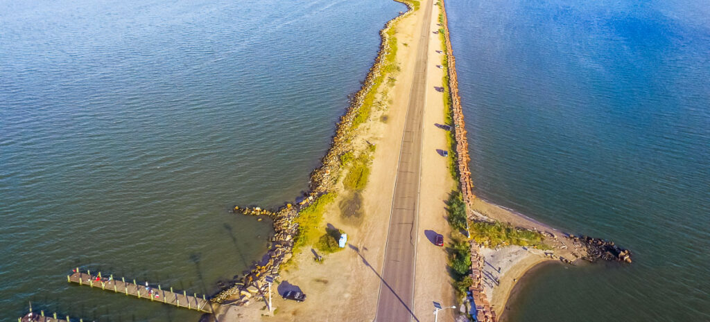 Panorama aerial view famous Texas City Dike with wooden piers, a levee that project nearly 5miles south-east into mouth of Galveston Bay. Designed to reduce impact of sediment accumulation along bay