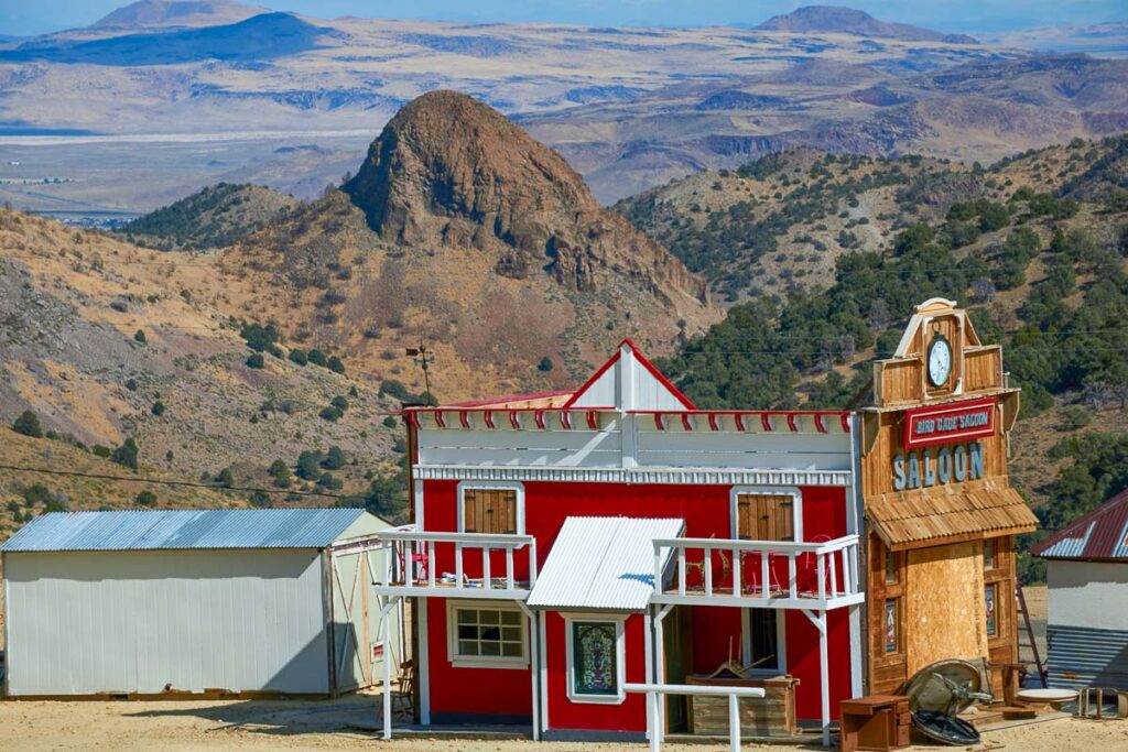 Colorful Red image of a Saloon with mountains in the background in Virginia City, Nevada