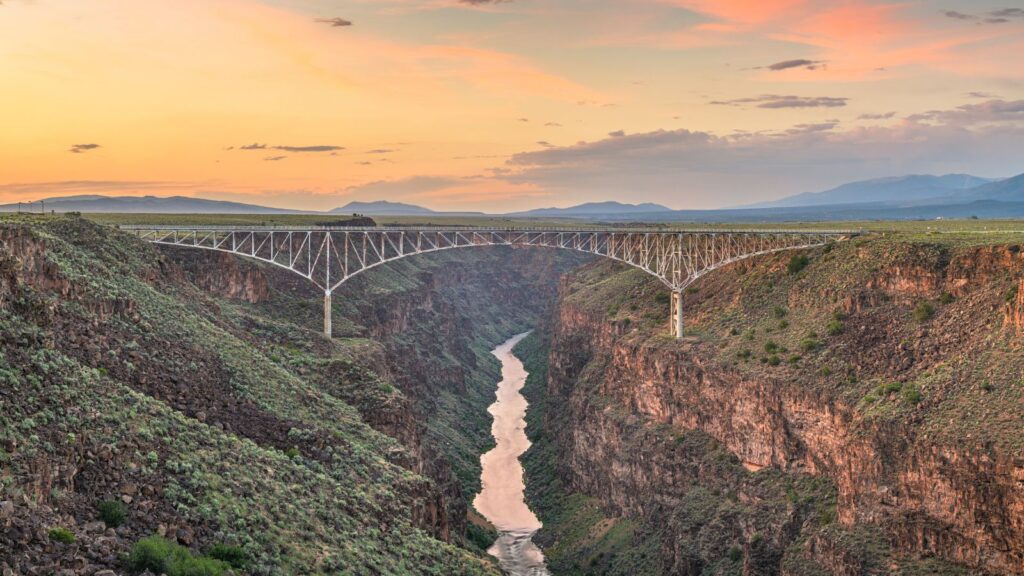 dusk orange sky over Rio Grande Gorge Bridge, New Mexico