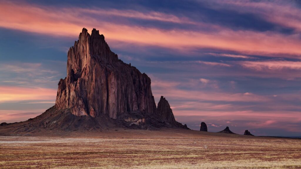 purple sky at dusk over rock formation in  Shiprock, New Mexico