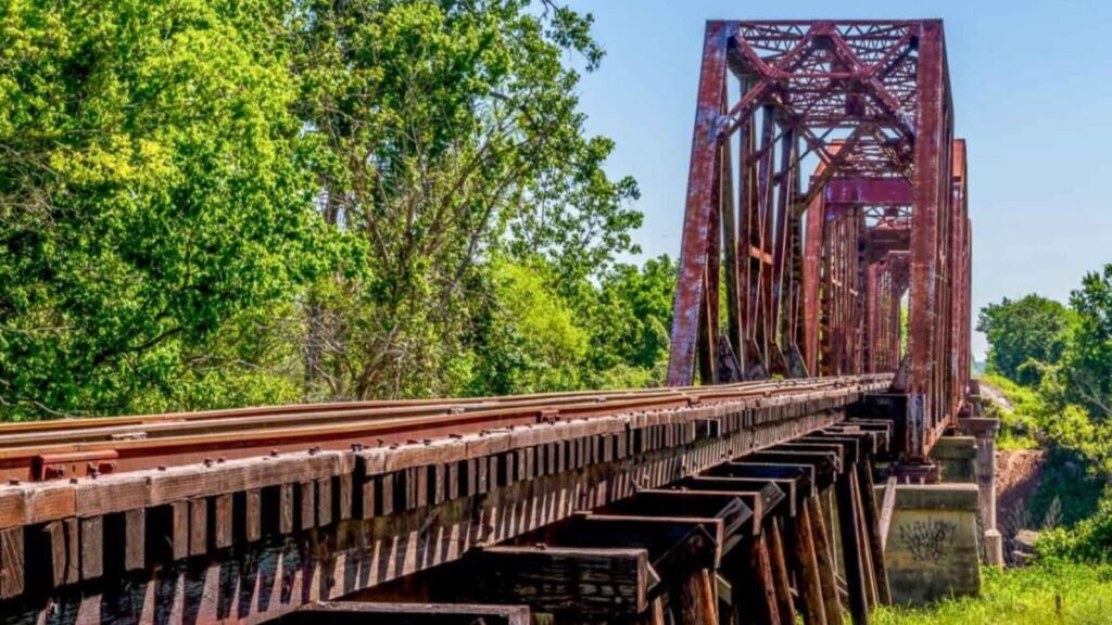 Old train bridge in Texas surrounded by trees