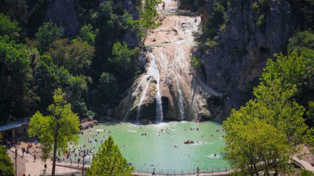 Medium wide aerial shot of Turner Falls Arbuckle Mountains in Oklahoma