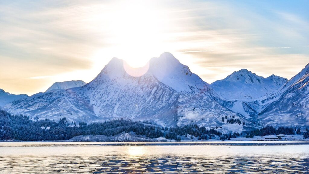 Sun peering over the Price William Sound in Alaska