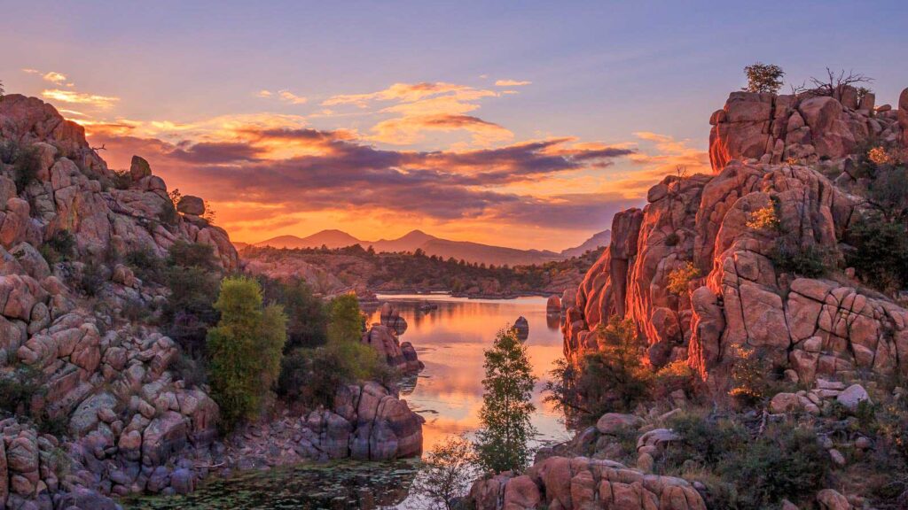 The boulders breached in a lake in Prescott during the sunset