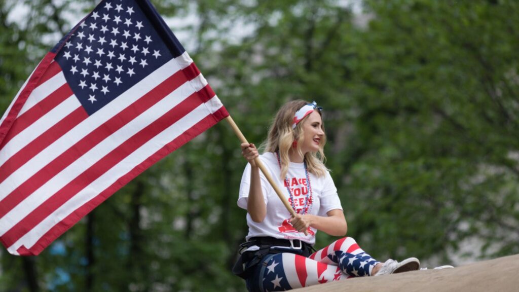 young woman holding the US flag