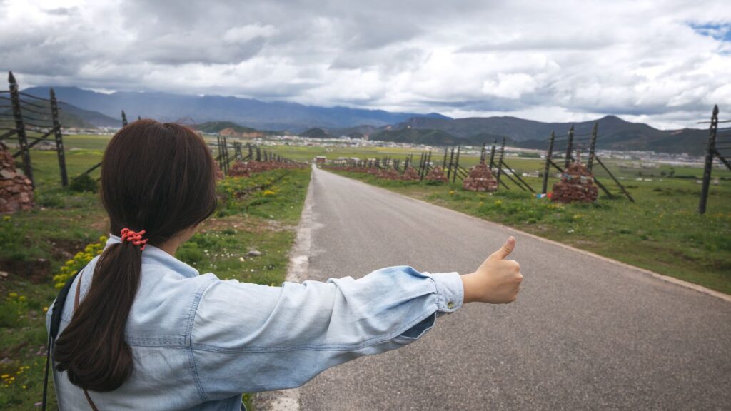 Girl hitchhiker in farmland