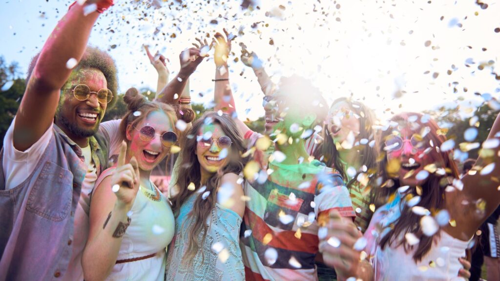 Group of Friends throwing glitter at a Festival