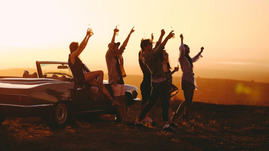 Group of friends on a road trip at sunset